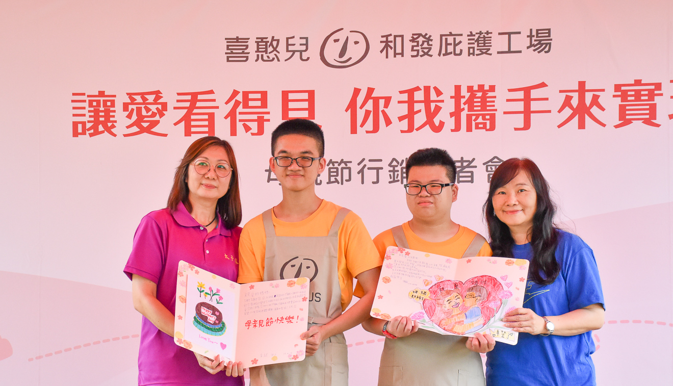 ▲憨兒小廷.小毅母子檔出席活動宣傳母親節商品。（圖/喜憨兒基金會提供）
