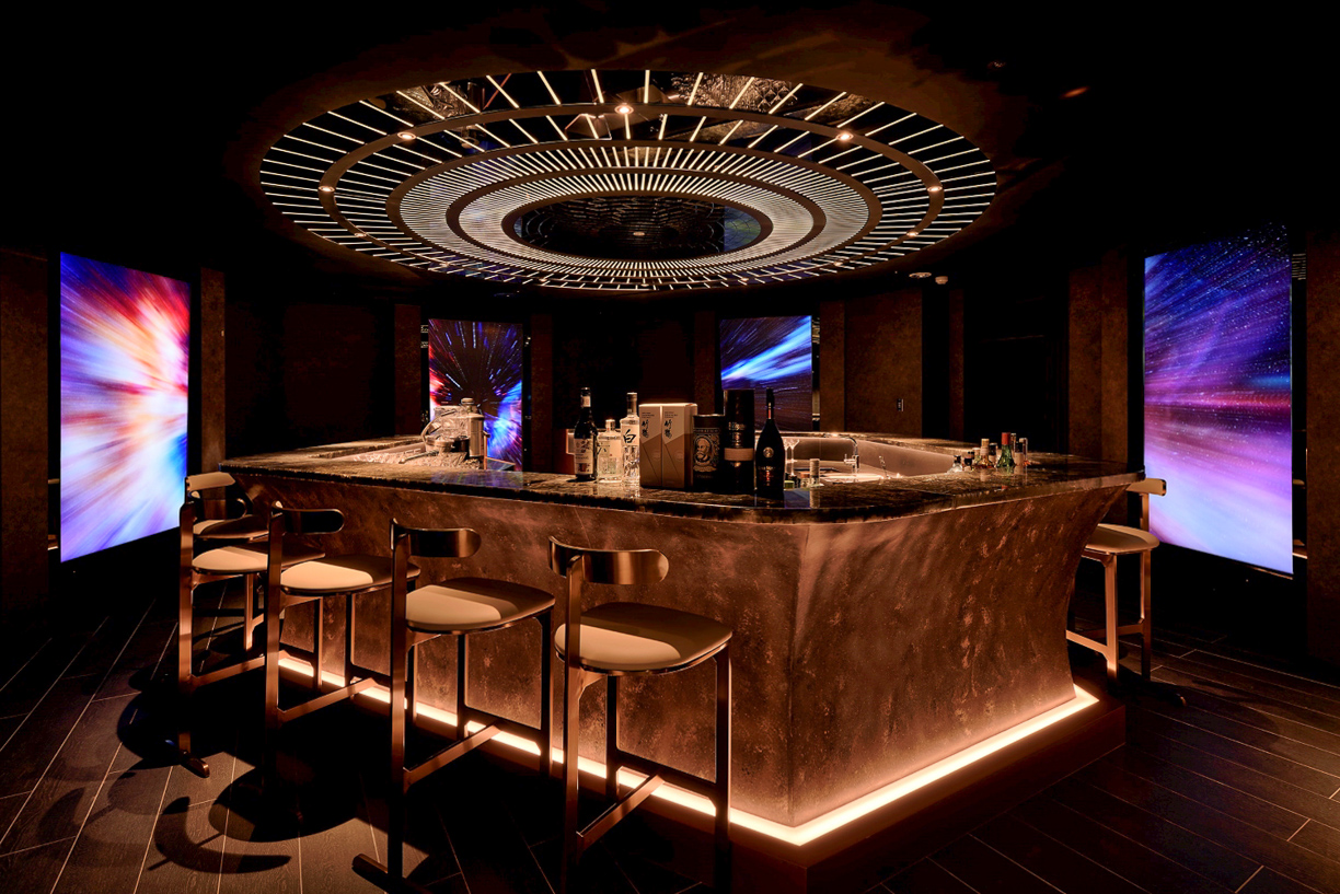 ▲SSBar的用餐空間設計前衛，調酒吧檯圍繞巨幅螢幕，放映宇宙星空的錄像作品，為館內拍照打卡熱點之一。（圖/御盟集團提供）